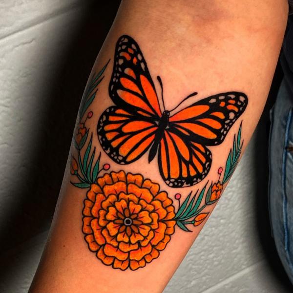 Stylized marigold and monarch butterfly tattoo