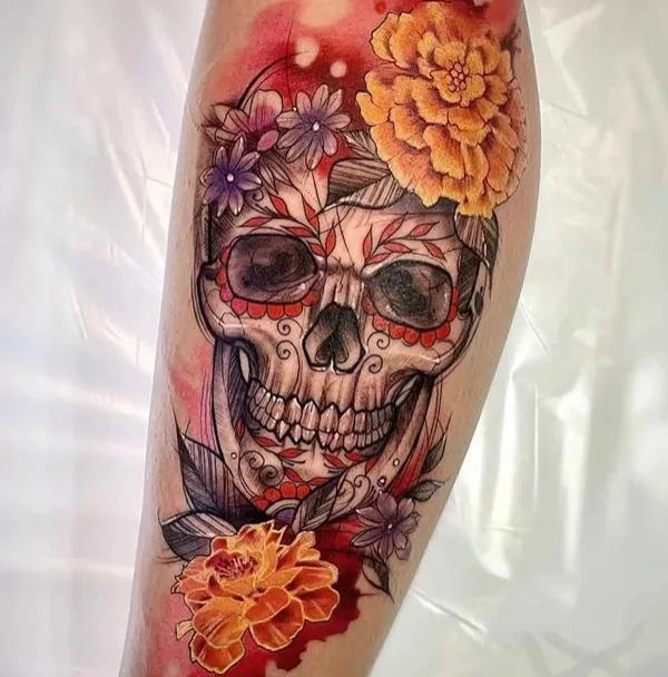 Sugar skull adorned with leaves and marigold