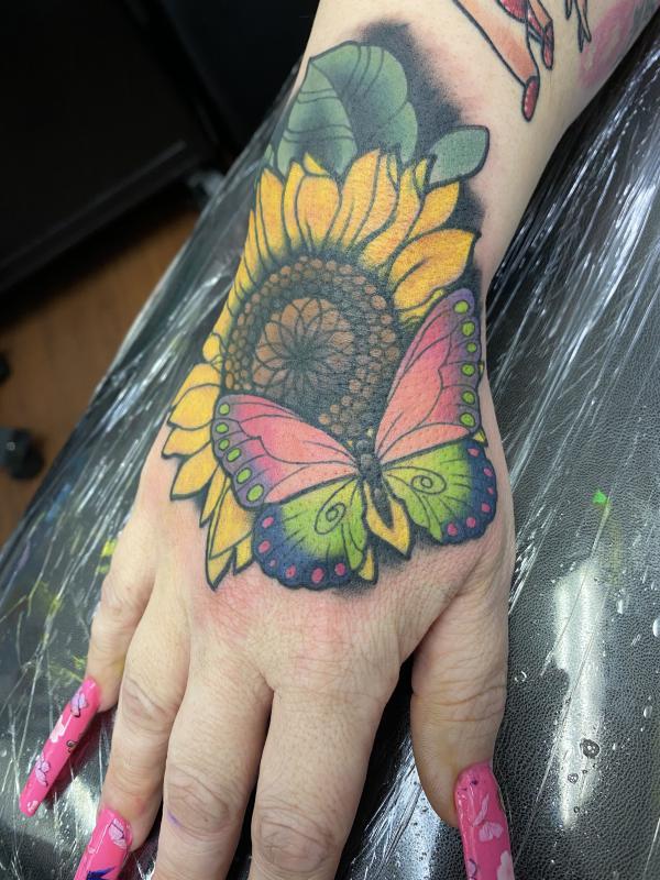 Sunflower and butterfly hand tattoo
