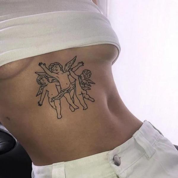 Three Cherubs sternum tattoo