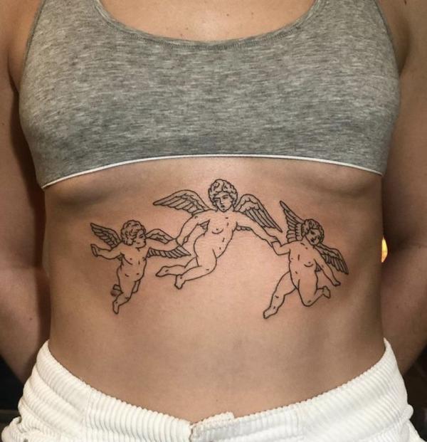 Three dancing cherubs sternum tattoo