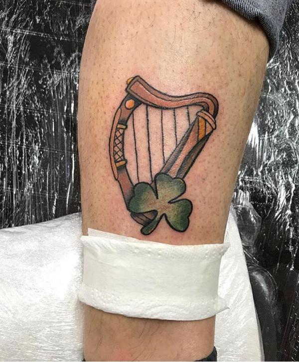 Traditional Irish harp with shamrock tattoo