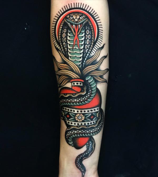 Traditional cobra wrapping around sacred heart tattoo