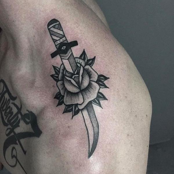 Traditional dagger and rose shoulder tattoo black and white