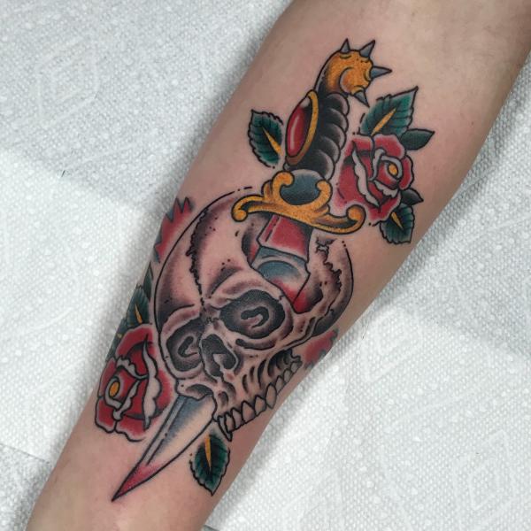 Traditional dagger and skull with roses tattoo