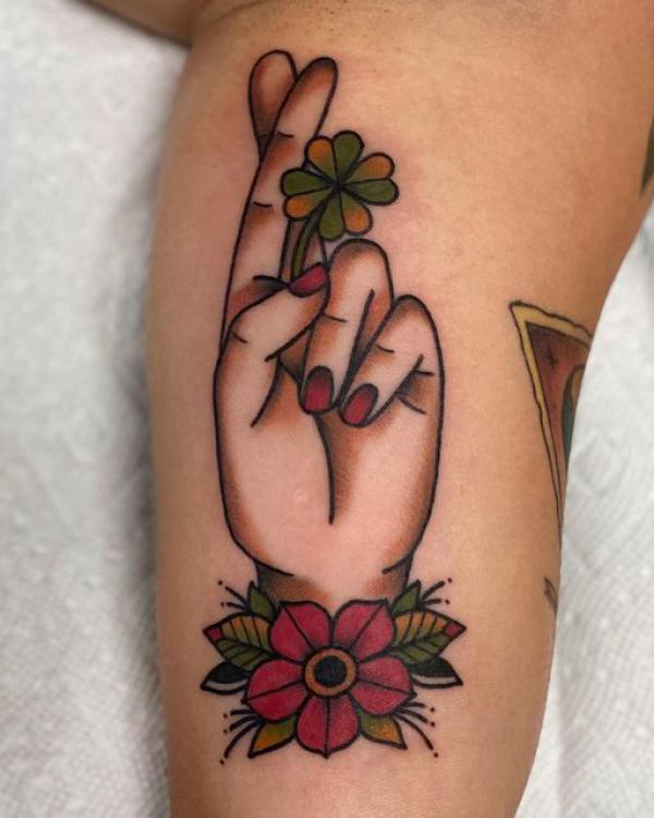 Traditional hand with a clover tattoo