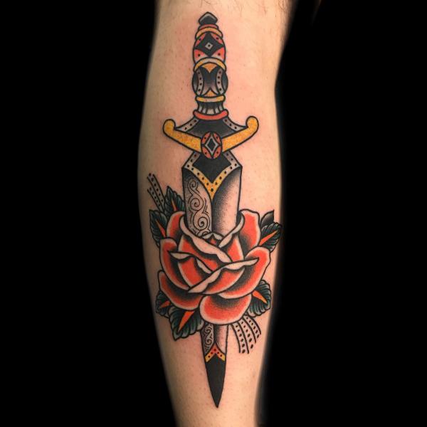 Traditional rose and dagger tattoo forearm