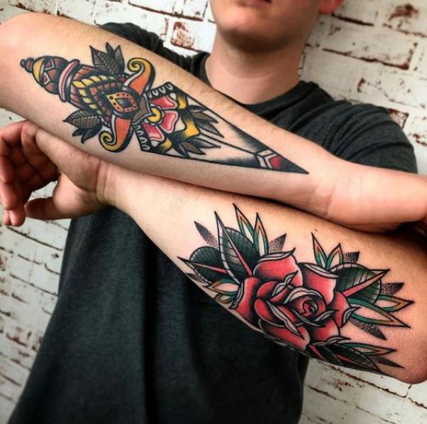 Traditional rose and dagger tattoo on forearms