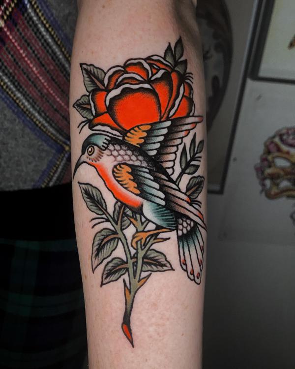 Traditional rose with stem and a bird tattoo