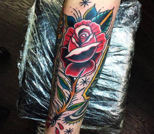 Traditional rose with thorns forearm tattoo
