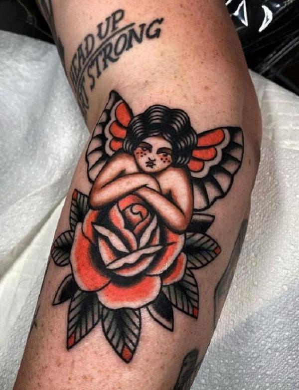 Traditional cherub and rose tattoo