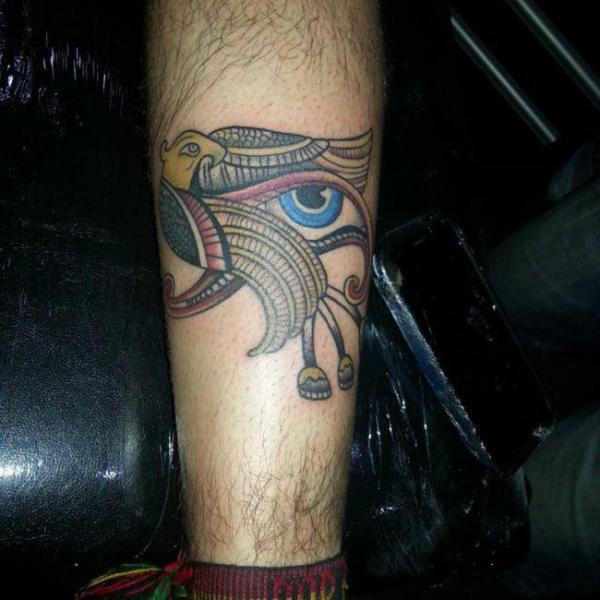 Traditional falcon and eye of Ra tattoo