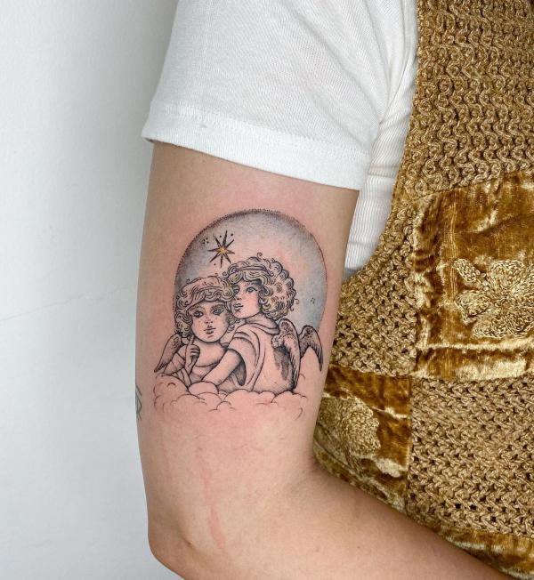 Two Cherubs with moon and star arm tattoo