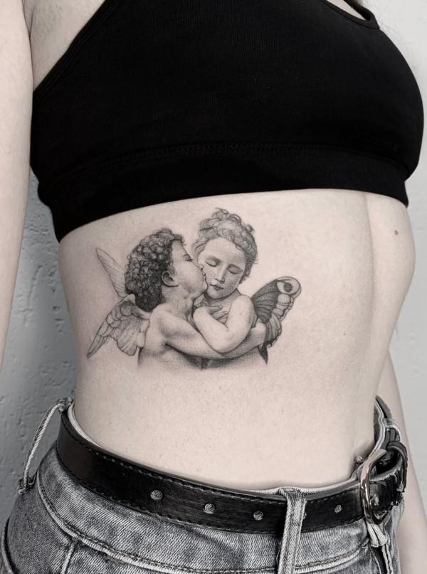 Two kissing cherubs side tattoo