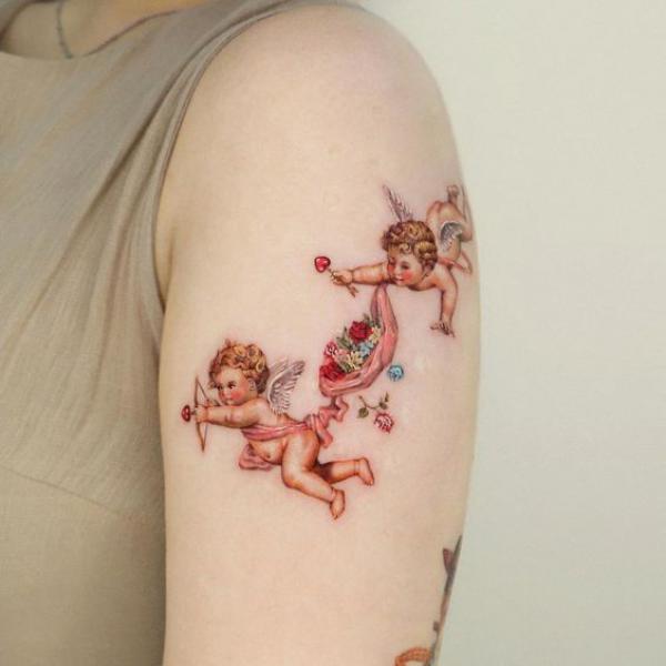 Two playful cherubs tattoo