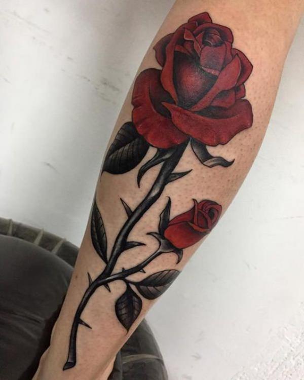 Vibrant red rose with thorns tattoo