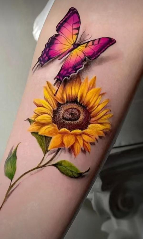 Vibrant sunflower and red butterfly tattoo