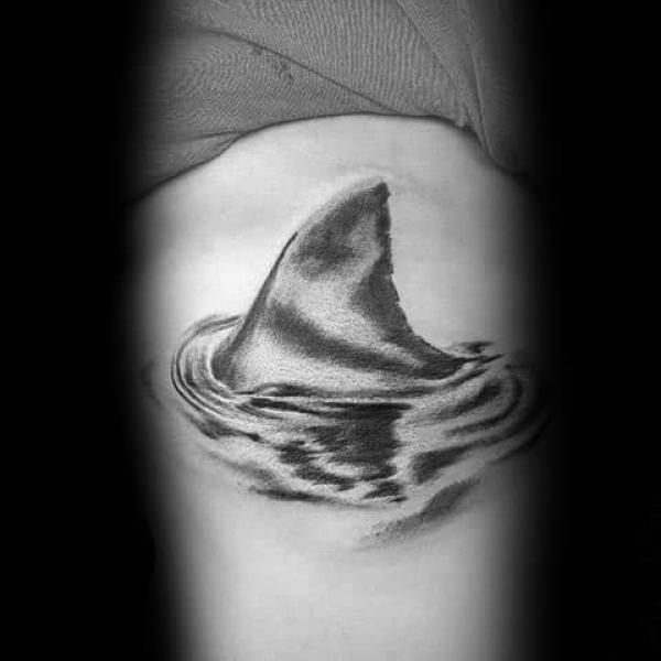 Wave and shark fin tattoo