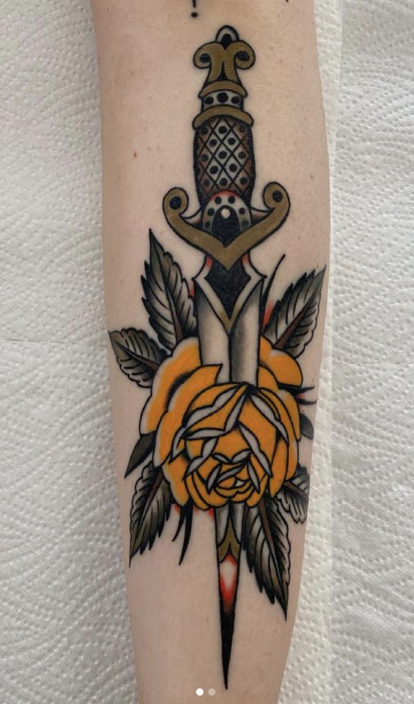 Yellow rose and dagger tattoo