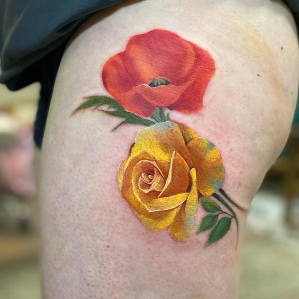 Yellow rose and red poppy thigh tattoo