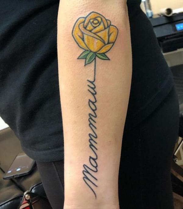 Yellow rose with words as stem tattoo for mum