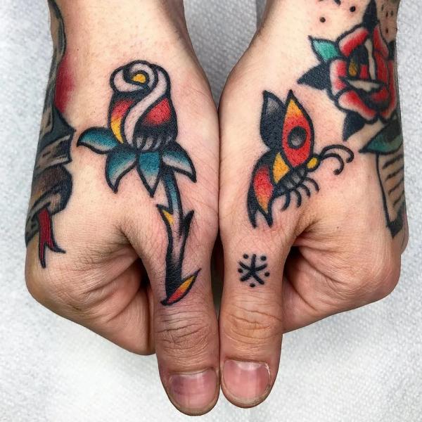 American traditional rose tattoo on thumb