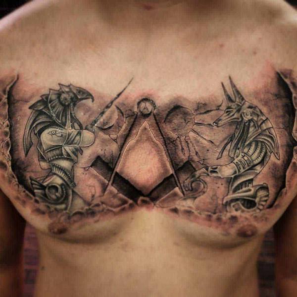Anubis and Horus stone tattoo on chest