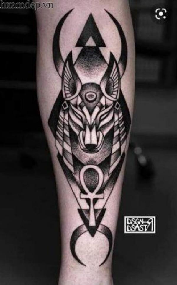 Anubis and crescent moon forearm tattoo