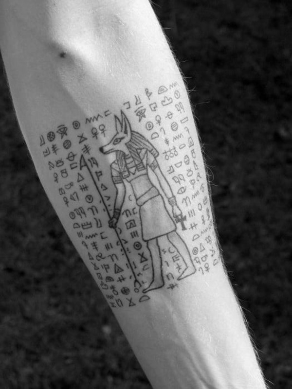 Anubis holding was scepter with hieroglyphics tattoo black and grey