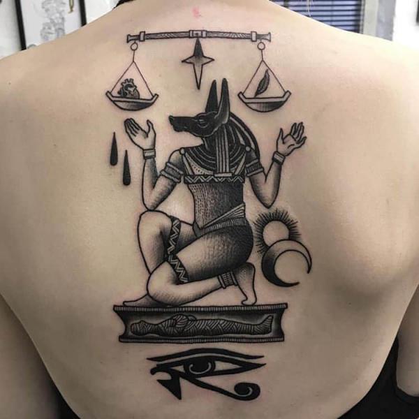 Anubis on coffin weighing life and death with Eye of Horus back tattoo