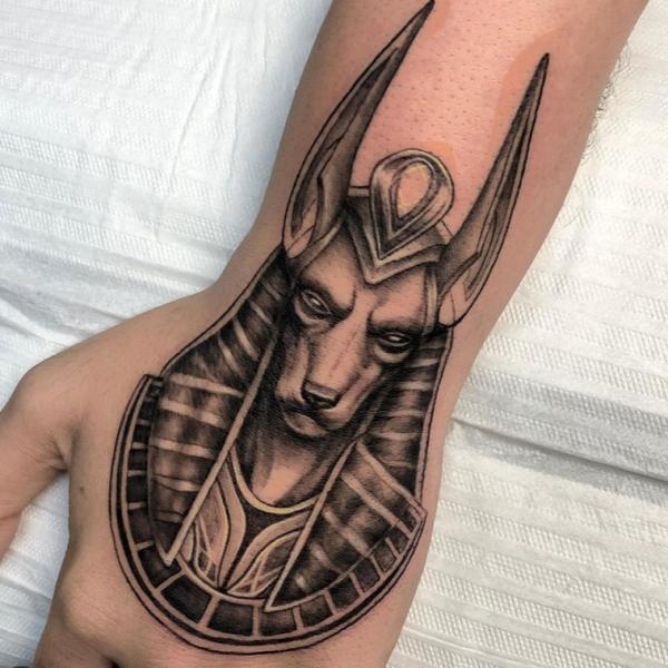 Anubis portrait hand tattoo