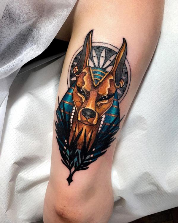 Anubis portrait tattoo above elbow