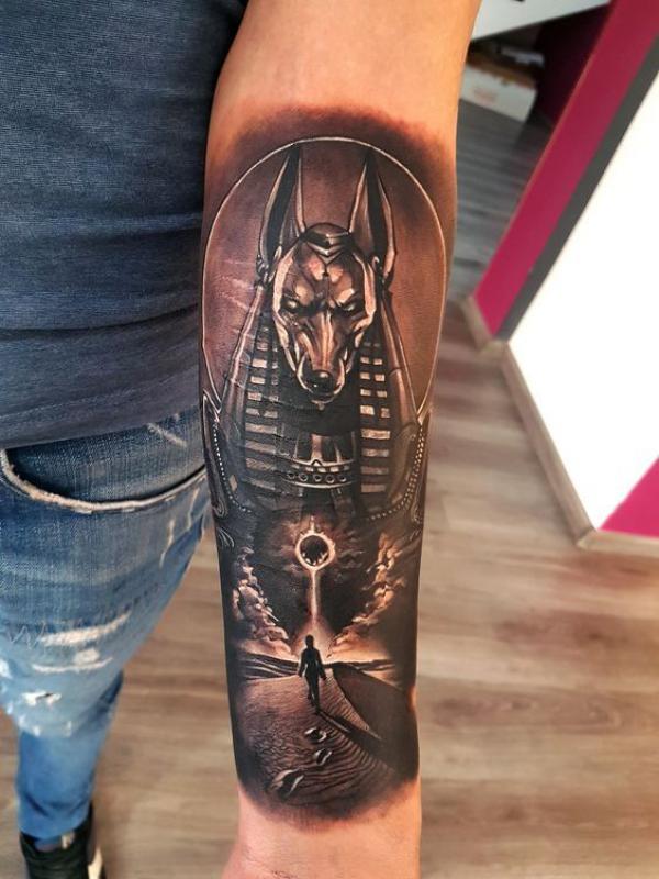 Anubis with nemes headdress tattoo on inner forearm