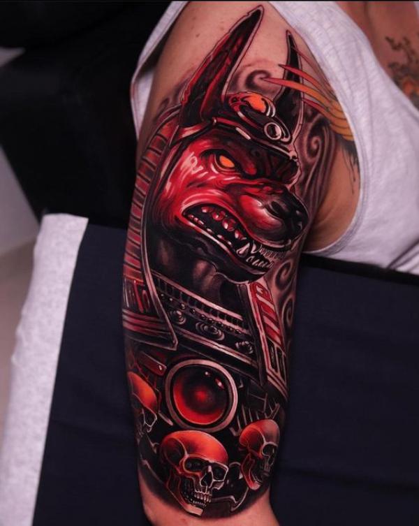 Anubis with skulls half sleeve tattoo