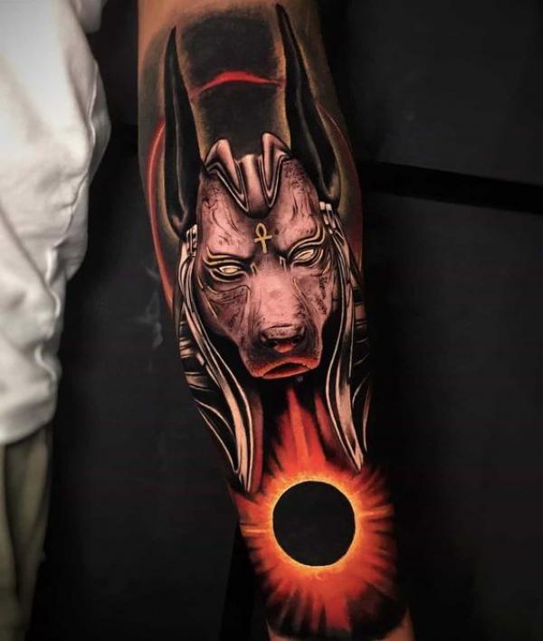 Anubis with solar eclipse forearm tattoo