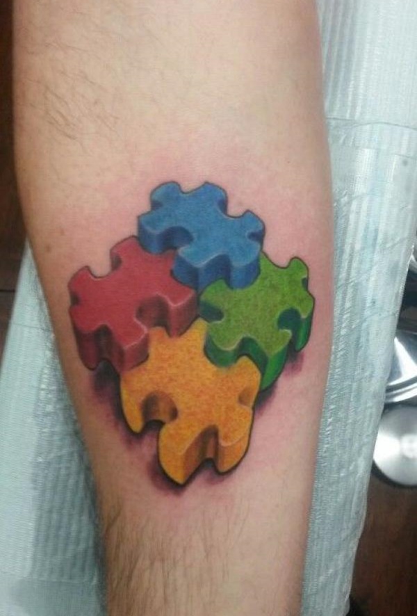 Autism puzzle tattoo on inner forearm