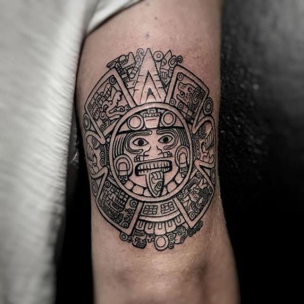 Aztec calendar line work tattoo above elbow