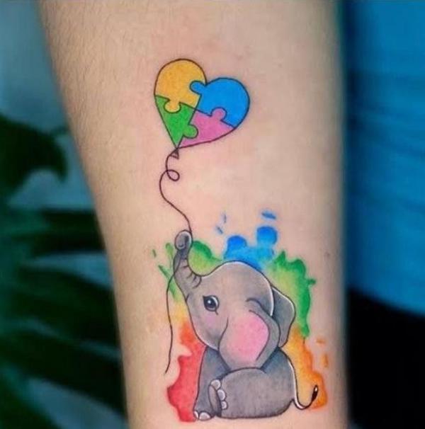 Baby elephant with puzzle heart tattoo