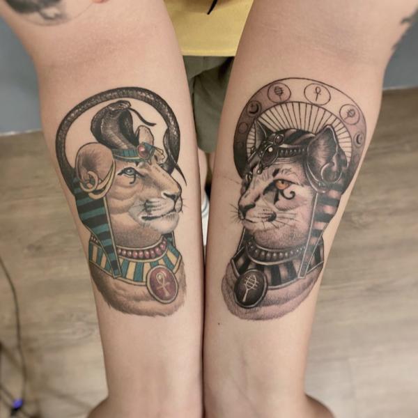 Bastet and Sekhmet tattoo on forearm