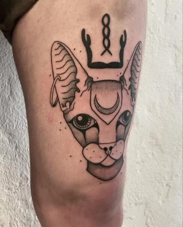 Bastet head thigh tattoo