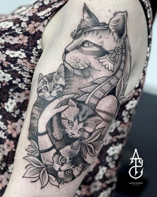 Bastet holding small cats tattoo black and grey