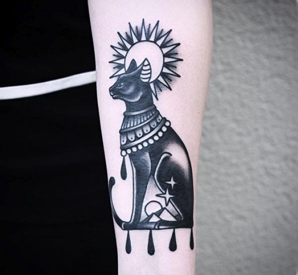 Bastet with sun and star tattoo