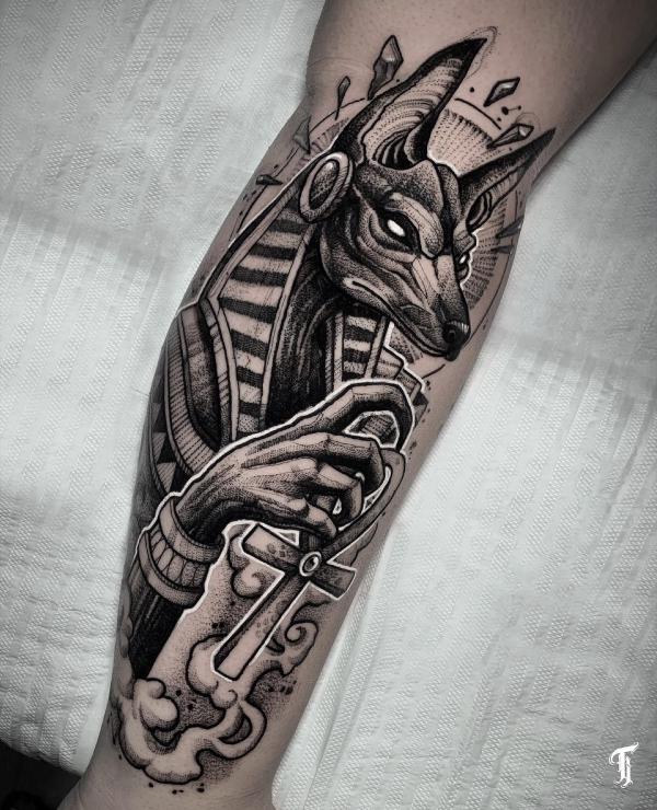 Black and grey Anubis holding Ankh cross tattoo