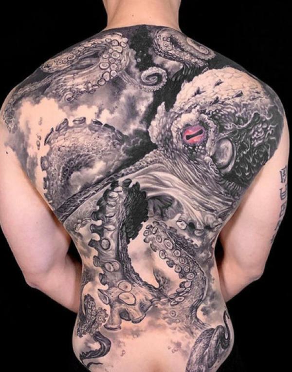 Black and grey kraken back tattoo