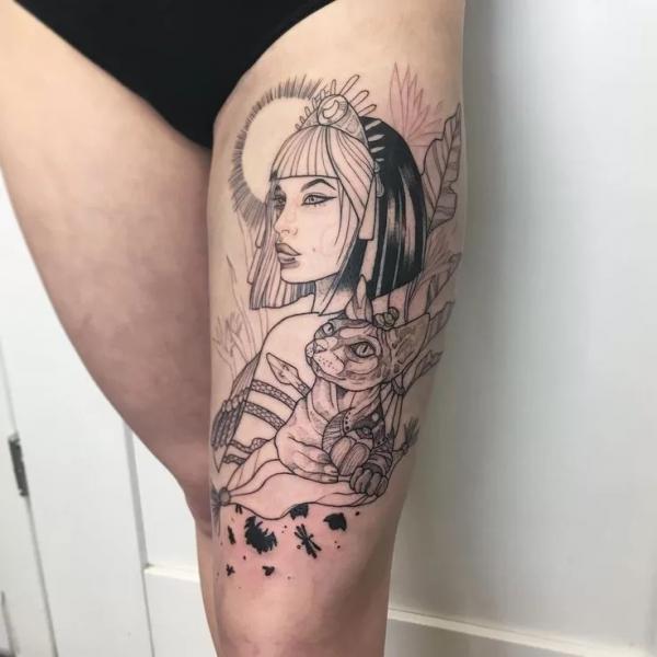 Black and white Cleopatra and cat thigh tattoo