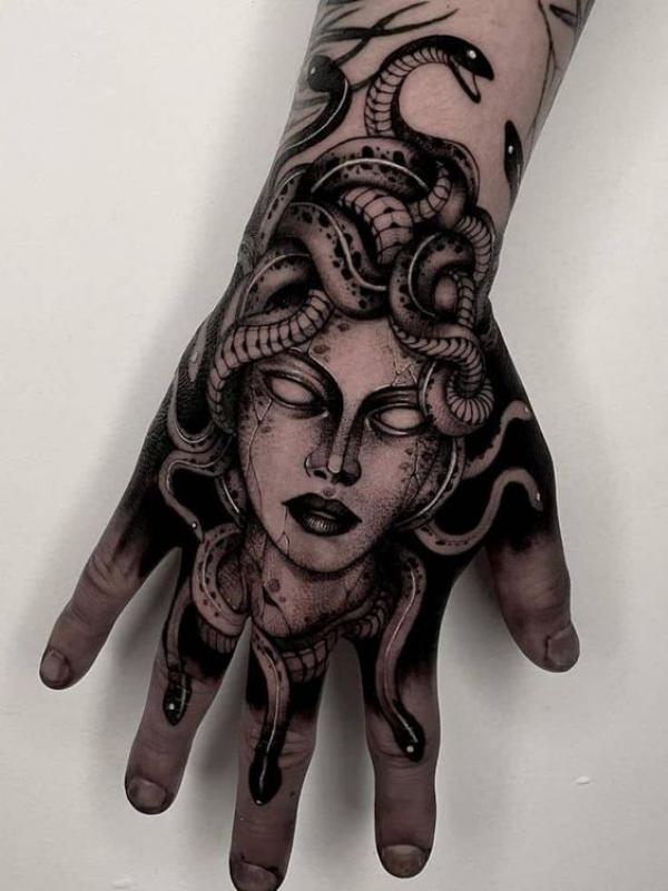 Black and white Medusa hand tattoo
