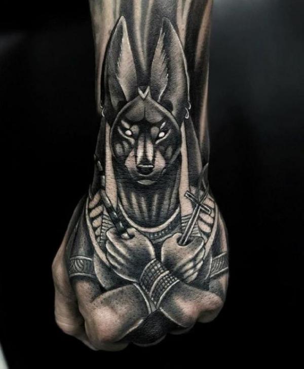 Blackwork Anubis hand tattoo