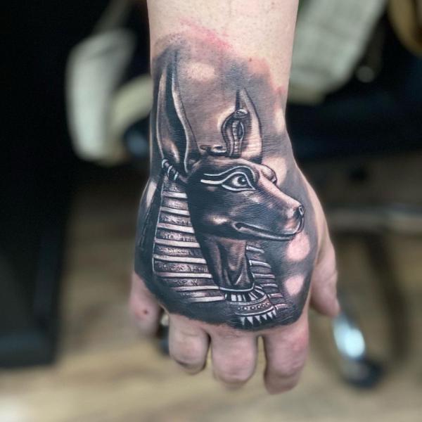 Blackwork Anubis tattoo on hand