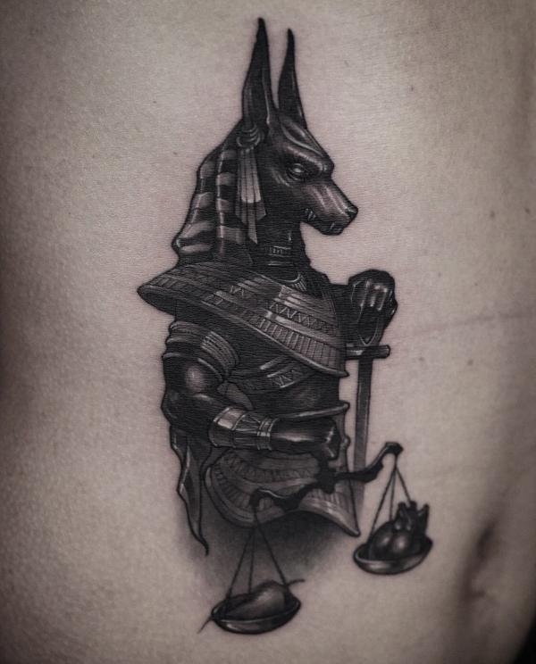 Blackwork Anubis weighing death and life tattoo