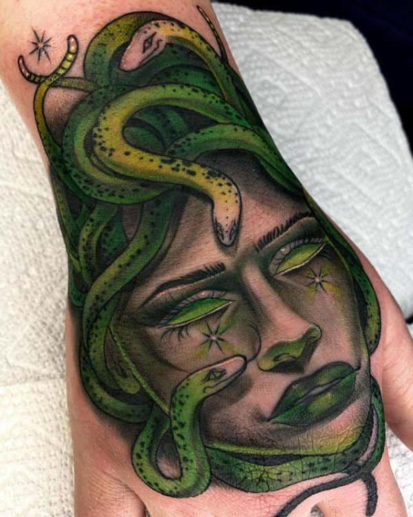 Blue Medusa with snake hand tattoo traditional